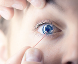 7506(25PR):  ERG-Jet Contact Lens Electrodes (25 Pairs) Close up of doctor using ERG Jet eye electrode on patient's eye