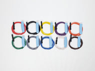 Ten subdermal EEG needle electrodes with baby blue protective sheath over needle with red, black, yellow, purple, orange, green, gray, blue, white, and brown lead-wires