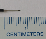 Needle electrode next to ruler to show 0.7 cm needle length